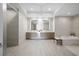 Luxurious bathroom with double vanity, soaking tub, and modern finishes at 401 Quay Commons # 901, Sarasota, FL 34236