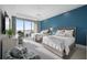 Guest bedroom with two beds, water views, and soothing blue accent wall at 401 Quay Commons # 901, Sarasota, FL 34236