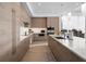 Modern kitchen with wood cabinets, quartz countertops, and stainless steel appliances at 401 Quay Commons # 901, Sarasota, FL 34236