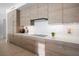 Modern kitchen with wood cabinets, quartz countertops, and stainless steel appliances at 401 Quay Commons # 901, Sarasota, FL 34236