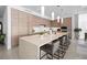 Modern kitchen with large island and light wood cabinets at 401 Quay Commons # 901, Sarasota, FL 34236