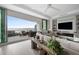 Living room with sliding doors leading to a balcony with water views at 401 Quay Commons # 901, Sarasota, FL 34236