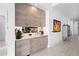 Stylish wet bar with wood cabinets and countertop at 401 Quay Commons # 901, Sarasota, FL 34236