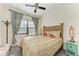 Cozy bedroom with bamboo headboard, soft carpet, and natural light at 4223 Overture Cir, Bradenton, FL 34209