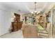 Dining room with glass table, wood hutch, and light tile floors at 4223 Overture Cir, Bradenton, FL 34209