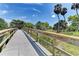 Wooden footbridge leads through lush greenery and palm trees at 4223 Overture Cir, Bradenton, FL 34209