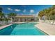 Community pool with lounge chairs and covered seating at 4226 Fairway Pl, North Port, FL 34287