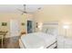 Bedroom with access to a bathroom, wood floors, and a cozy bed at 4628 Pine Green Trl # 9, Sarasota, FL 34241