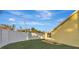 Landscaped backyard with a privacy fence and grassy area at 5101 Island Date St, Sarasota, FL 34232