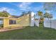 Side yard view of the house with grassy area at 5101 Island Date St, Sarasota, FL 34232