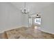 Bright dining room with tile floors and chandelier, open to living room at 5101 Island Date St, Sarasota, FL 34232