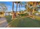 House exterior showcasing a large yard, mature trees, and a white fence at 5101 Island Date St, Sarasota, FL 34232
