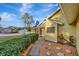 Charming yellow home with landscaped walkway, flowering bushes, and a well-maintained green lawn at 5101 Island Date St, Sarasota, FL 34232