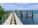 Wooden dock with benches overlooking the water at 5311 Gulf Of Mexico Dr # 6, Longboat Key, FL 34228