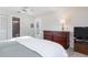 Bedroom with a king-size bed, dresser, and en-suite bathroom at 6190 80Th N St # 111, St Petersburg, FL 33709