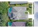 Aerial view of the property showcasing the pool, roof, and surrounding lush landscaping at 6476 Royal Tern Cir, Lakewood Ranch, FL 34202