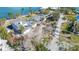 Aerial view showing house with storm damage and surrounding trees at 6516 Bayou Hammock Rd, Longboat Key, FL 34228