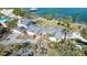 Aerial view of waterfront home with damage from a storm at 6516 Bayou Hammock Rd, Longboat Key, FL 34228
