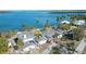 Aerial view of waterfront home with hurricane damage at 6516 Bayou Hammock Rd, Longboat Key, FL 34228