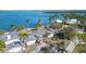 Aerial view of waterfront home with hurricane damage at 6516 Bayou Hammock Rd, Longboat Key, FL 34228