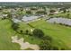 Aerial view of community with clubhouse, pool, golf course, and tennis courts at 6609 Stone River Rd # 104, Bradenton, FL 34203