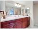 Bathroom with double vanity and large mirror at 6609 Stone River Rd # 104, Bradenton, FL 34203