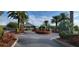 Exterior view of the clubhouse, featuring landscaping and palm trees at 6609 Stone River Rd # 104, Bradenton, FL 34203