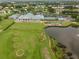 Aerial view of community including clubhouse, pool, and tennis at 6609 Stone River Rd # 104, Bradenton, FL 34203