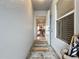 Bright entryway with tiled floor, open to living area, and a colorful rug at 6609 Stone River Rd # 104, Bradenton, FL 34203
