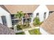 Condo building exterior with lush landscaping and screened patio at 6609 Stone River Rd # 104, Bradenton, FL 34203
