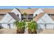 Front view of condo building showcasing attractive landscaping and building architecture at 6609 Stone River Rd # 104, Bradenton, FL 34203