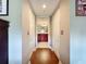 Hallway leading to bathroom with hardwood floors at 6609 Stone River Rd # 104, Bradenton, FL 34203