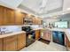 Well-equipped kitchen with wood cabinets, granite countertops, and modern appliances at 6609 Stone River Rd # 104, Bradenton, FL 34203