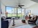 Sunroom with golf course view and comfortable seating at 6609 Stone River Rd # 104, Bradenton, FL 34203