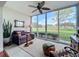 Sunroom with golf course view and comfy seating at 6609 Stone River Rd # 104, Bradenton, FL 34203
