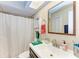 Clean bathroom with a single sink vanity, shower/tub combo and linen cabinet at 718 N Jefferson Ave # 718, Sarasota, FL 34237