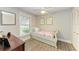 Charming bedroom with a twin bed, built-in shelving, and large window at 718 N Jefferson Ave # 718, Sarasota, FL 34237