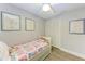Charming bedroom with twin bed, built-in closet, and whimsical wall art at 718 N Jefferson Ave # 718, Sarasota, FL 34237