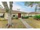 Exterior of a single-story home featuring a red door and walkway at 718 N Jefferson Ave # 718, Sarasota, FL 34237