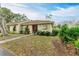 Neatly landscaped exterior of a single-story home with red door at 718 N Jefferson Ave # 718, Sarasota, FL 34237
