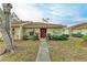 Front view of a single-story home with red door and walkway at 718 N Jefferson Ave # 718, Sarasota, FL 34237