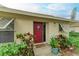 Front door entry with red door and potted plants at 718 N Jefferson Ave # 718, Sarasota, FL 34237
