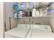 Practical laundry room with washer, dryer, and shelving at 718 N Jefferson Ave # 718, Sarasota, FL 34237