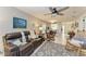 Cozy living room featuring a brown leather couch, rocking chairs, and decorative pillows at 718 N Jefferson Ave # 718, Sarasota, FL 34237