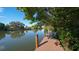Wooden dock with bench overlooking calm canal water at 850 S Tamiami Trl # 731, Sarasota, FL 34236