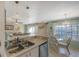 Kitchen with stainless steel appliances, breakfast bar, and view to dining area at 850 S Tamiami Trl # 731, Sarasota, FL 34236