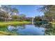 Serene pond with lush landscaping and reflection at 850 S Tamiami Trl # 731, Sarasota, FL 34236