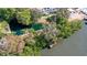 Arial view of waterfront property with private dock and lush vegetation at 850 S Tamiami Trl # 731, Sarasota, FL 34236