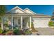 Inviting front porch with seating area and decorative planters at 899 Seascape Pl, Sarasota, FL 34240