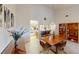 Dining room with chandelier, wood table, and built-in bookshelf at 1211 Capri Isles Blvd # 72, Venice, FL 34292